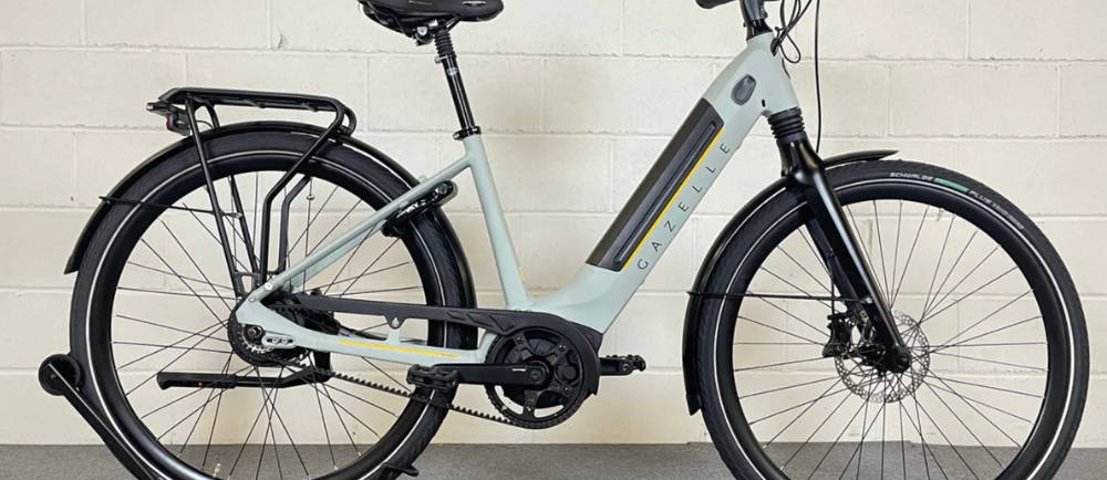A light green Gazelle Ultimate C380 step-thru electric city bike