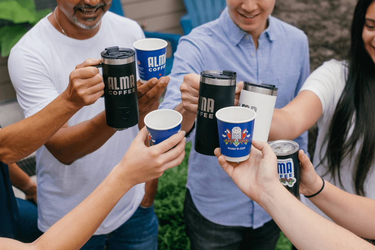 People cheering with steamed milk and espresso beverages