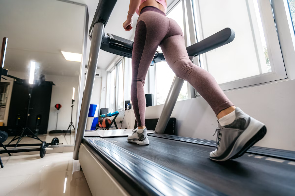 Woman on an incline treadmill Woman on an incline treadmill