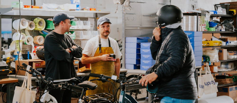 Upway mechanic and customers at Garage Sale event