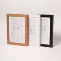 Wood, black, and white color variants of the Montessori Keepsake Frame. 