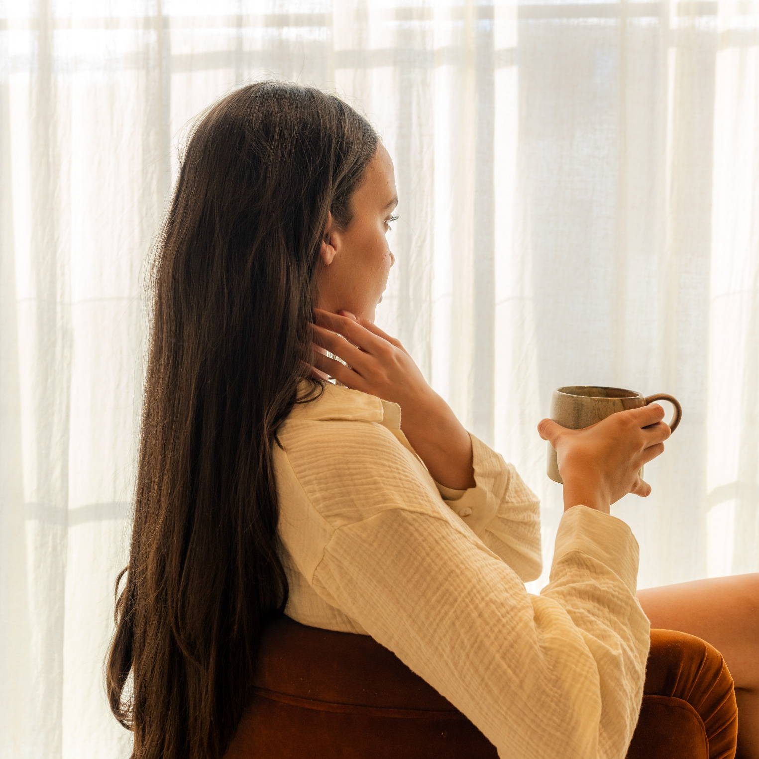 woman relaxing in a chair with a mug
