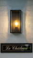 Outdoor wall light with exposed bulb adding warmth to entry facade in Rouse Hill by Havit