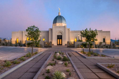 Tucson Temple picture glowing against an evening sky.