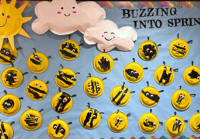 student made bees out of paper plates, paint, and pipe cleaners