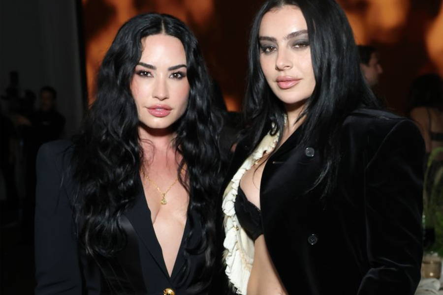 Image may contain: Charli XCX, Demi Lovato, Black Hair, Hair, Person, Adult, Clothing, Coat, Jacket, Face, and Head