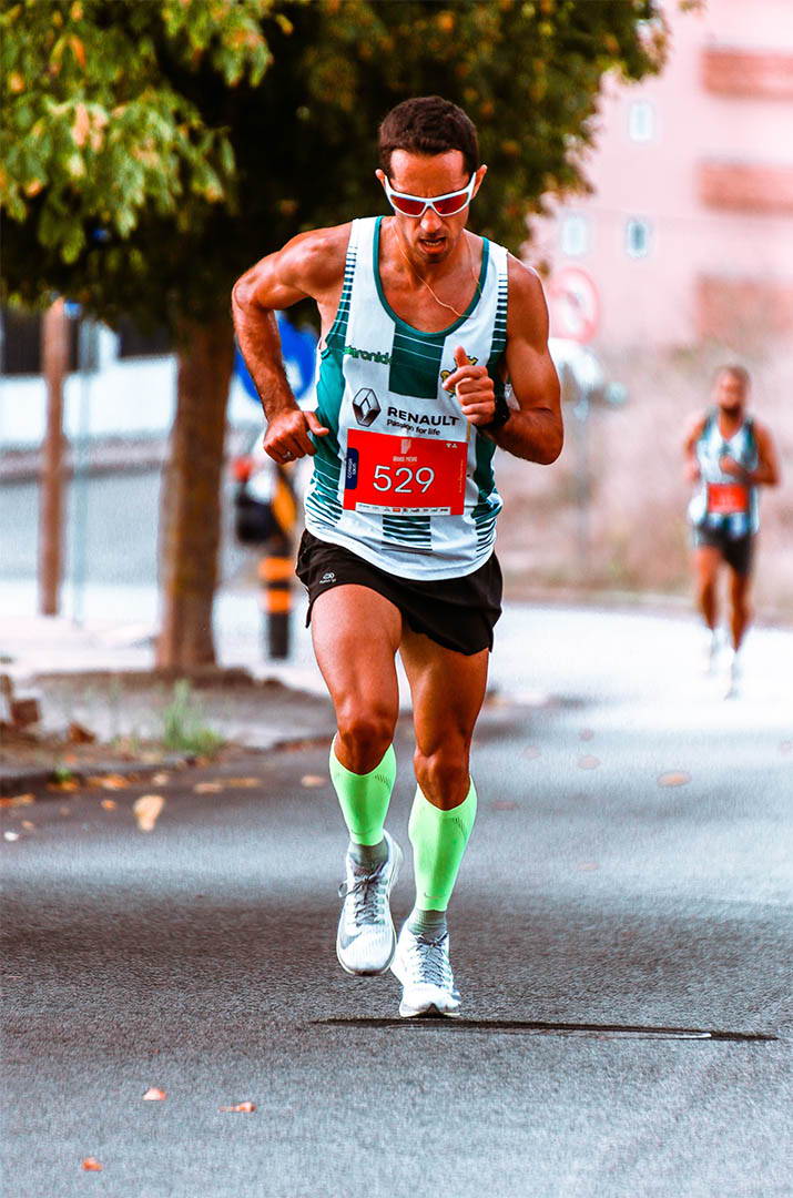 Man running with compression sleeves