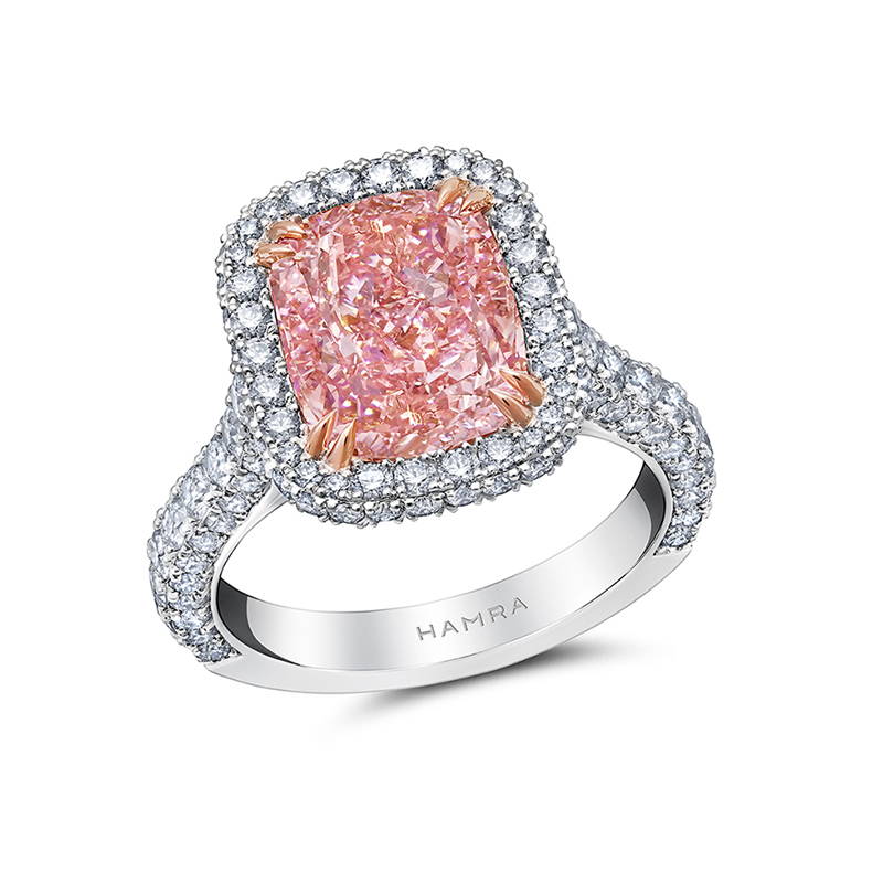 Pink diamond engagement ring with white diamond accents.