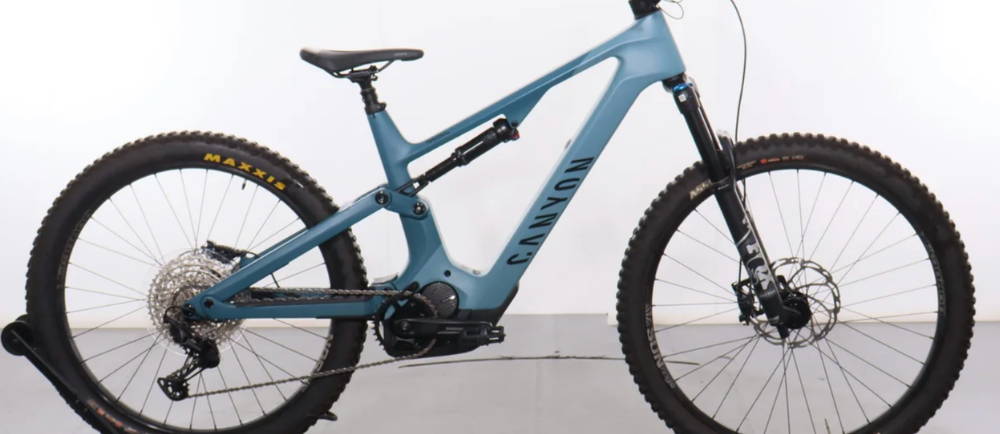 a baby blue Canyon Spectral CF 9 E-Bike full suspension electric mountain bike