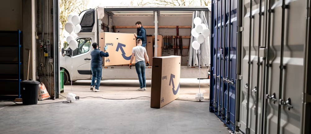 Upway workers loading bike boxes into truck
