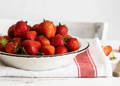 Bowl of strawberries on a white table