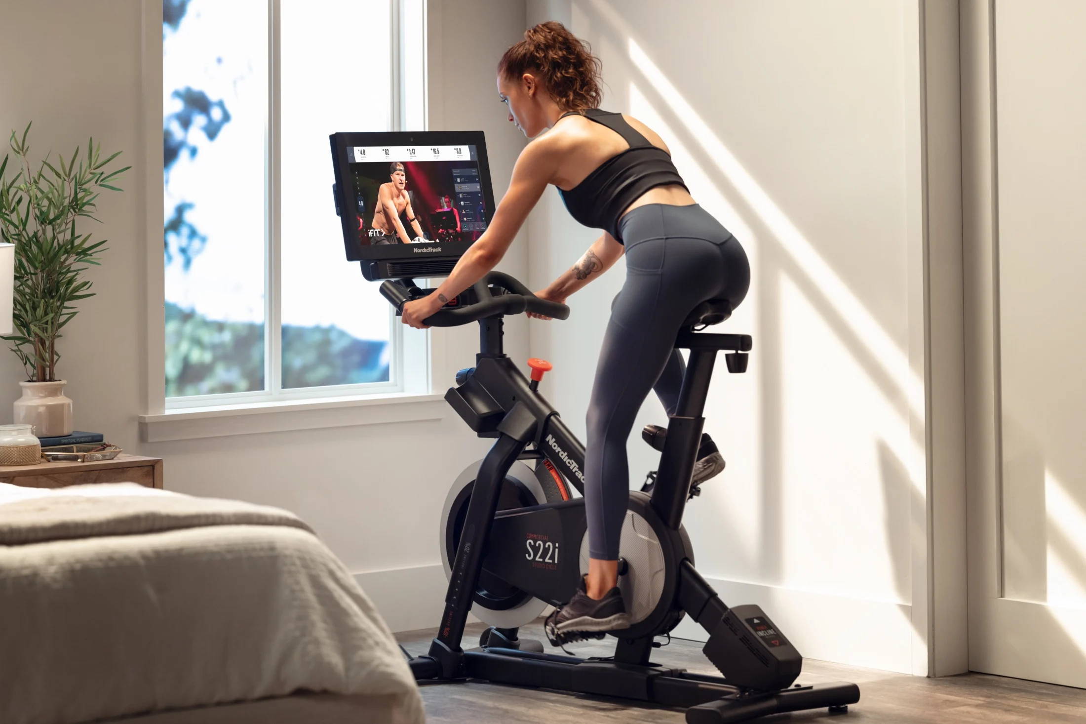 female workout on commercial bike at home