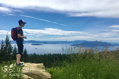 A hiker looking out at a viewpoint.