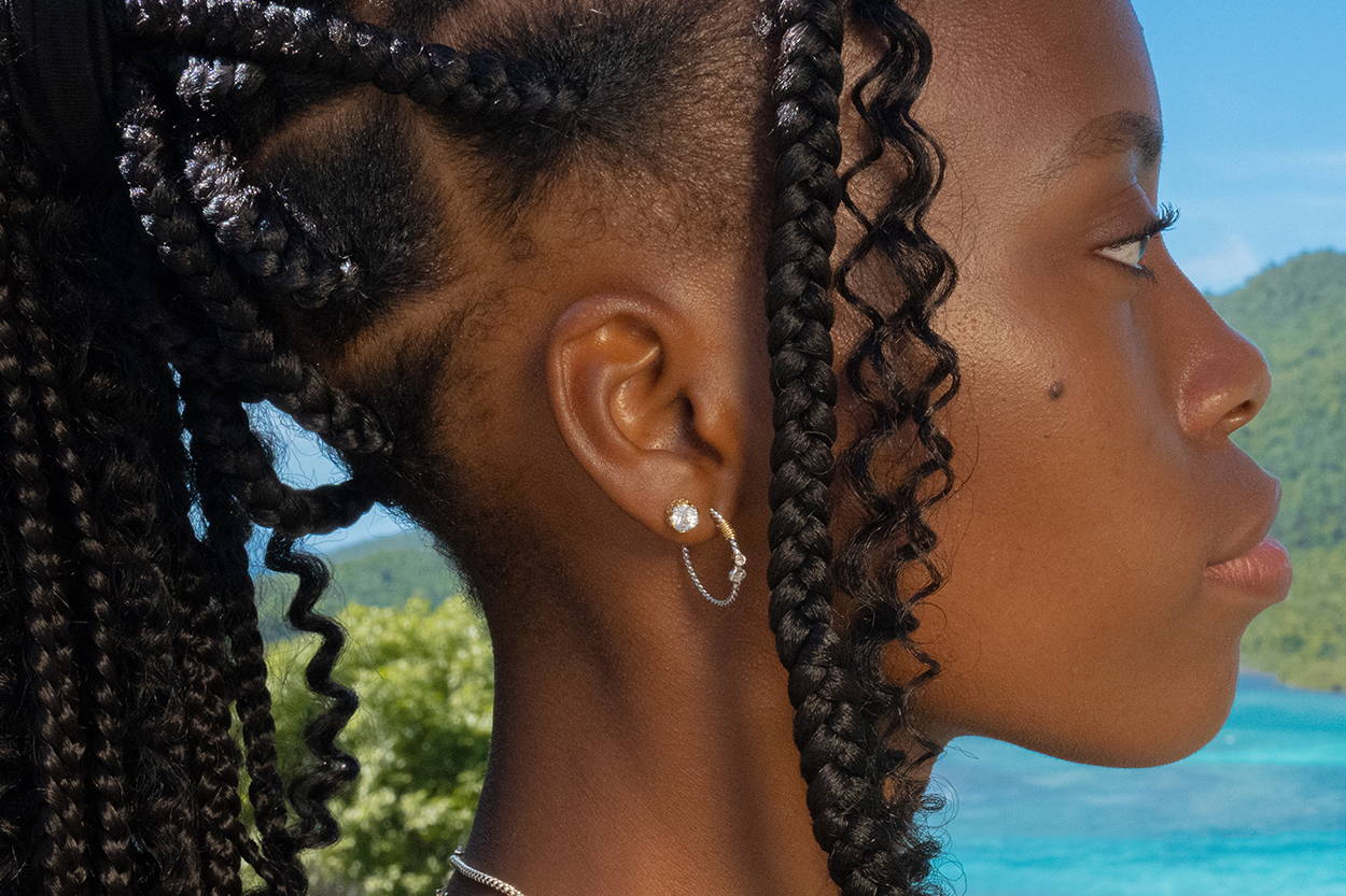 Side profile of a women wearing Vibe Jewelry stud and hoop earrings.