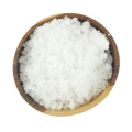 A small wooden bowl full of thick sea salt flakes