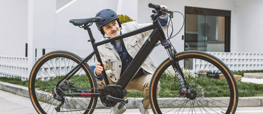 Rider with helmet checking his city electric bike