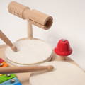 Wooden instrument block, a bell, and drums on the Montessori Percussion Set.