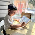 Boy playing with a magnetic maze color sorting game in a playroom. 