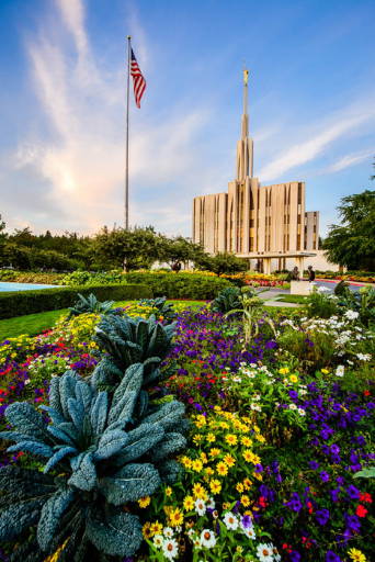 Vertical Seattle temple picture featuring a lush flower bed.