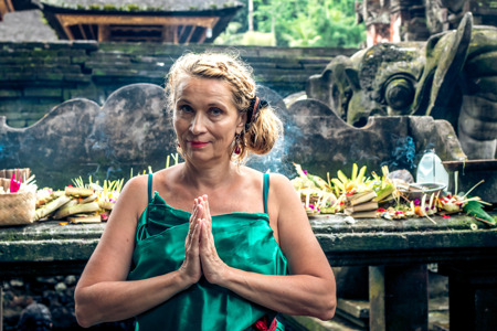 European woman at Pura Tirta Empul temple during a religious ceremony in Tampa, Bali,.jpg