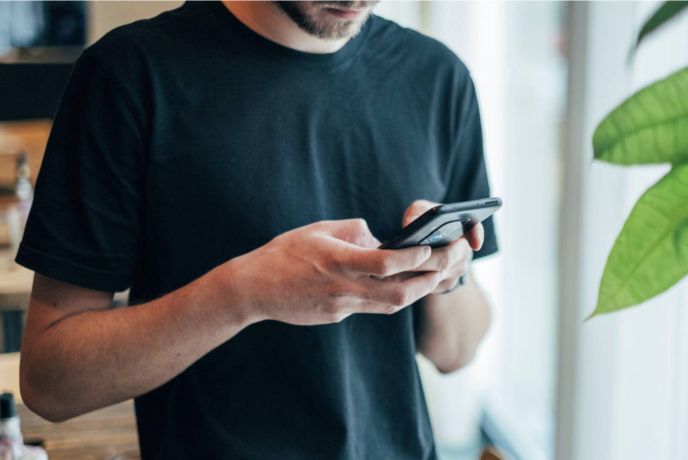 what is text neck: man bending over to text