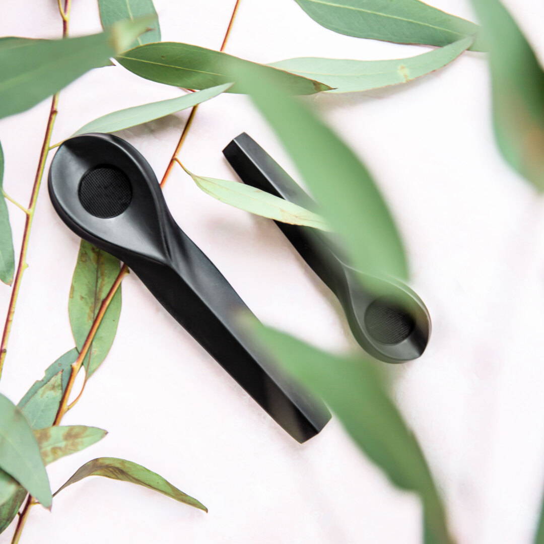 KOL and KOL mini pipe surrounded by green leaves