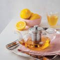 transparent teapot with metal infuser - brewing lemon tea