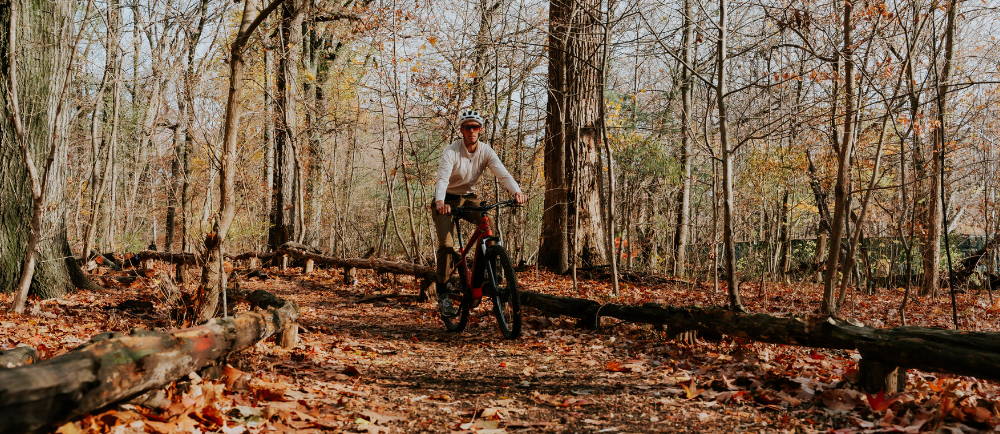 a man riding an e-bike in the forest
