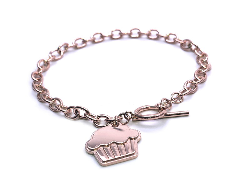 rose gold charm bracelet with a muffin-shaped charm in rose gold