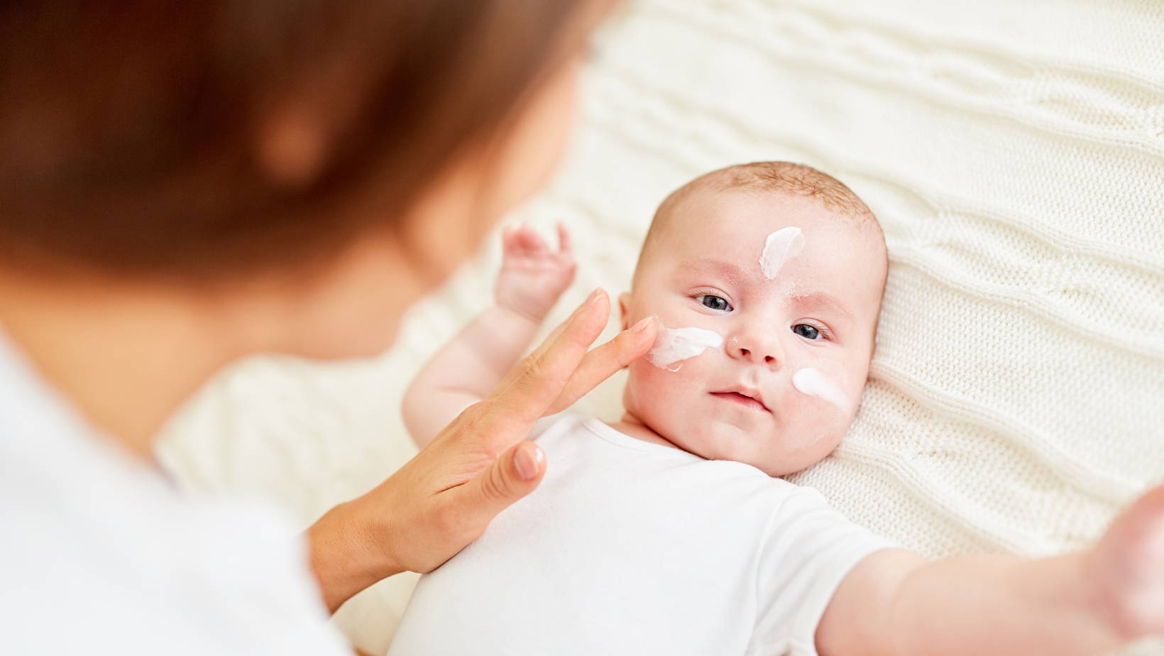 Mom putting Lotion on babys face | My Organic Company