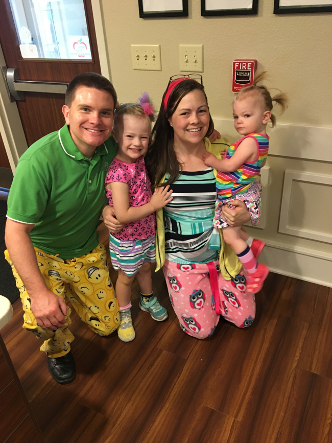The Schultz family pose with their two young children dressed in mismatched, wacky clothes