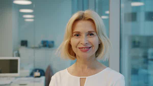 Smiling female healthcare professional in a modern clinic, symbolizing medical care and health expertise.