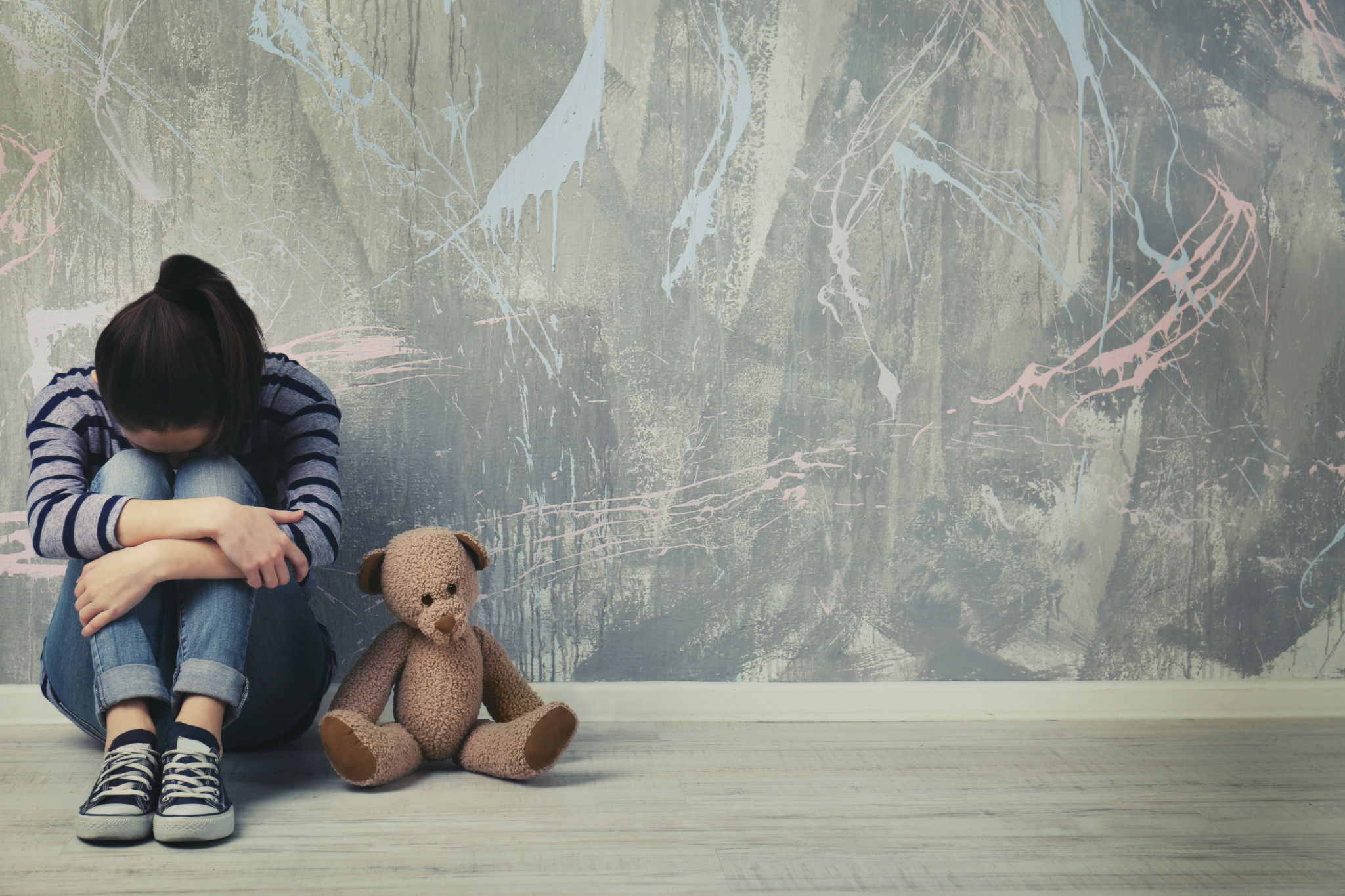 sad child with teddy bear