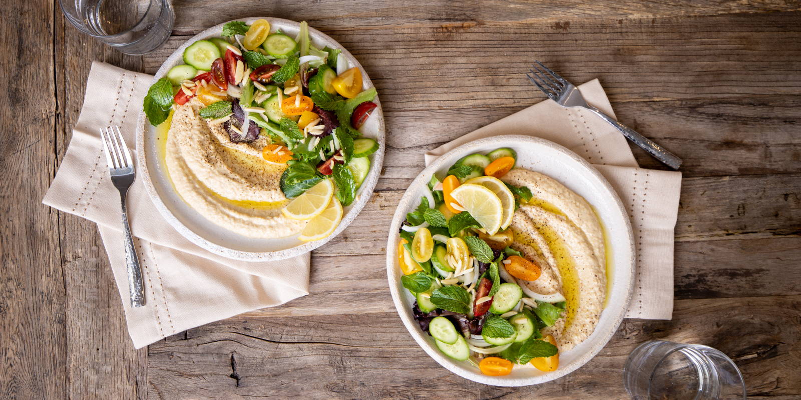 Serving hummus at home as a salad dressing and complete healthy vegan, plant-based meal.