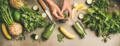 hands working to combine different fruits and vegetables, including three bottles of green juice