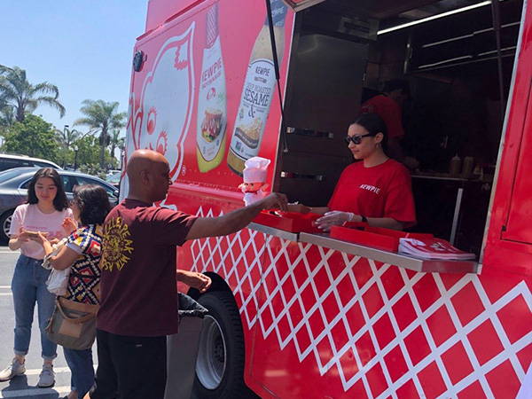 Receiving food order at Kewpie food truck