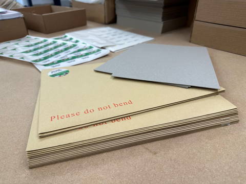 Recyclable board backed envelopes used for label deliveries