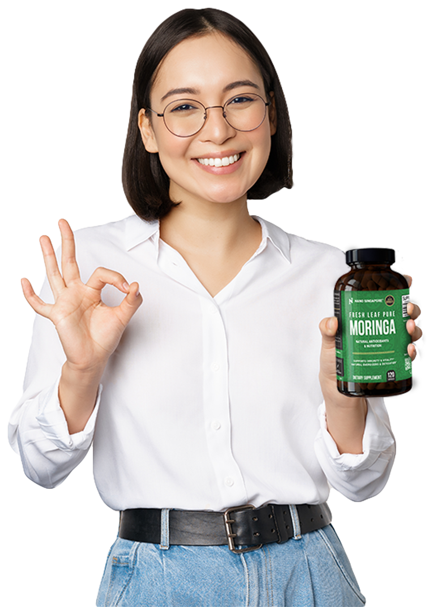 Woman holding up a bottle of the best moringa supplement