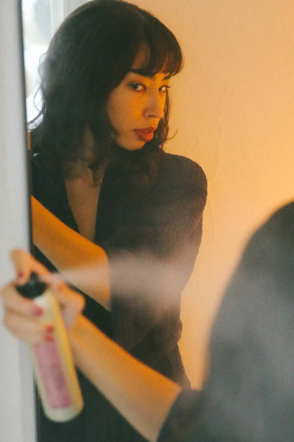 woman using Davines This is a Shimmering Mist