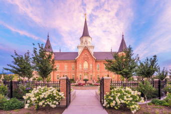 Provo City Center Temple gateway with white flower bushes.