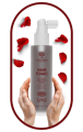 A bottle of NANOSKIN Hair Tonic surrounded by petal of roses