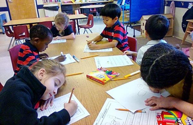 Students writing down and drawing on their paper