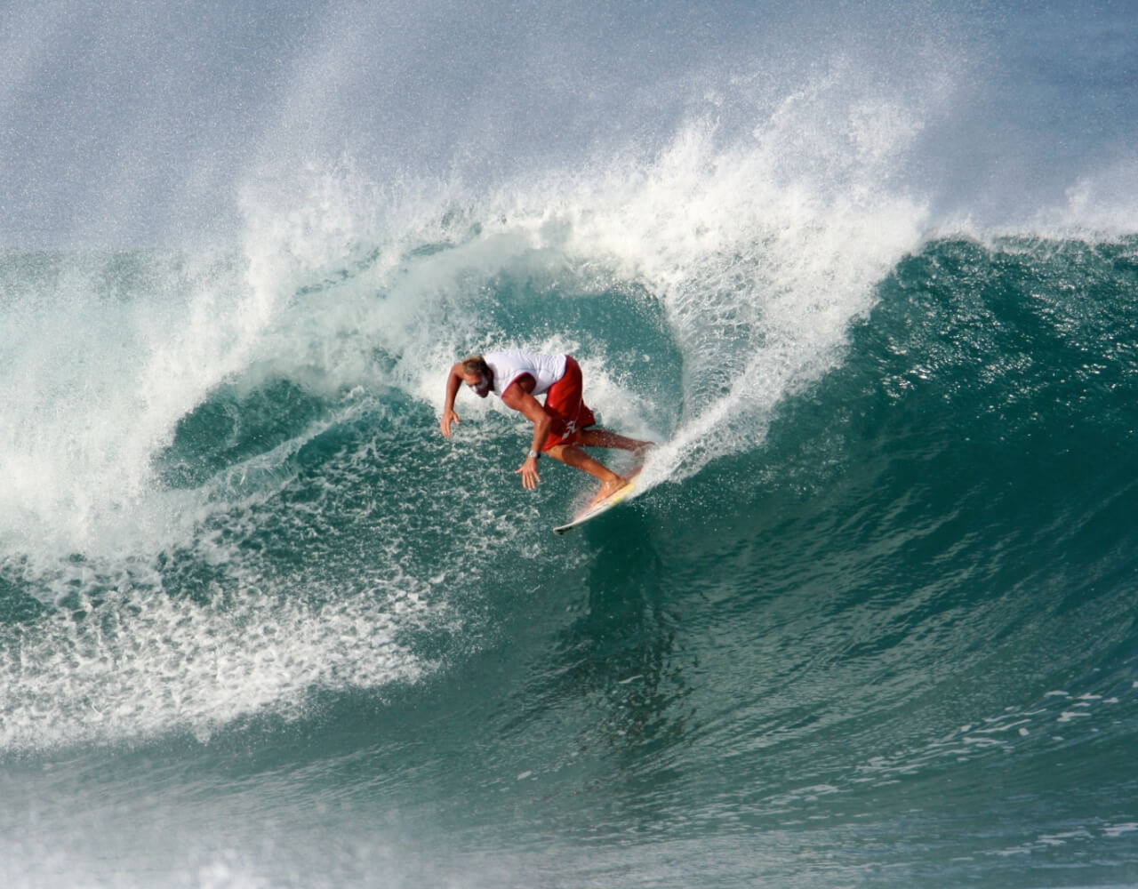 Chuck riding a wave on a surfboard
