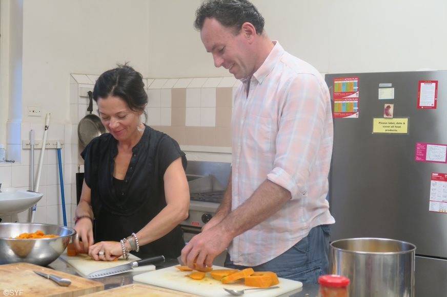 Two sevites preparing vegetables in kitchen