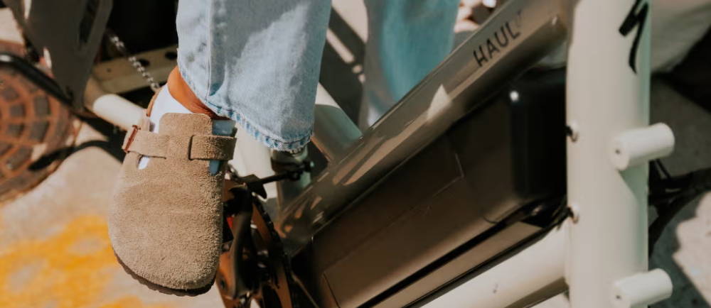 a woman in birkenstocks riding a Specialized Globe Haul ST compact electric cargo bike