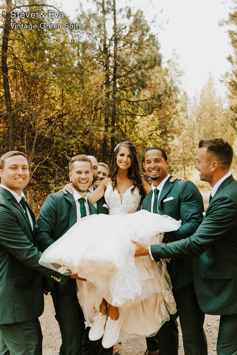 groomsmen in green suits carrying the bride