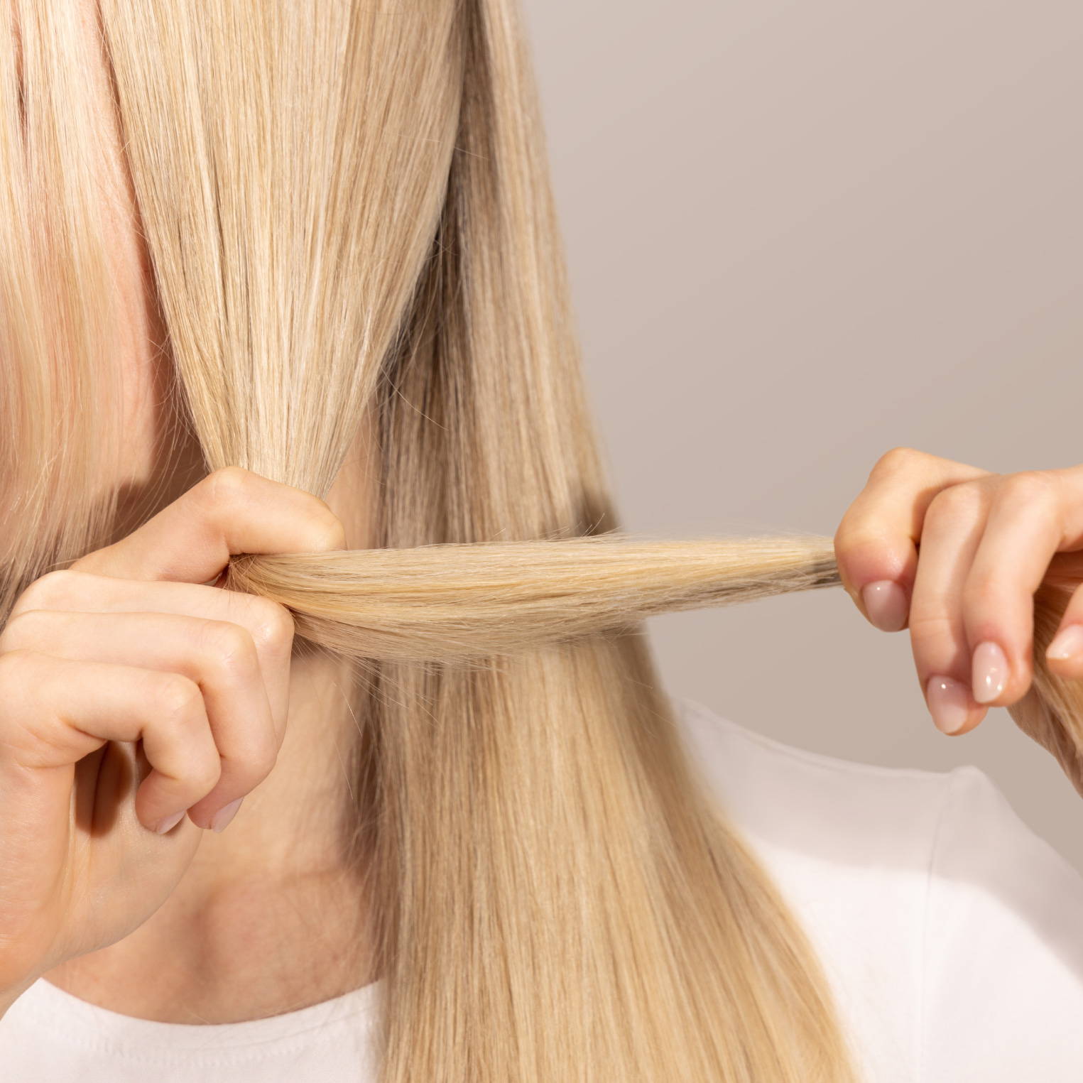 woman tugging on her blonde hair