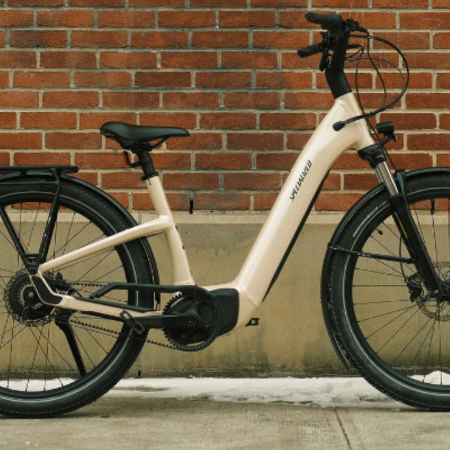 a tan Specialized Turbo Como electric city bike