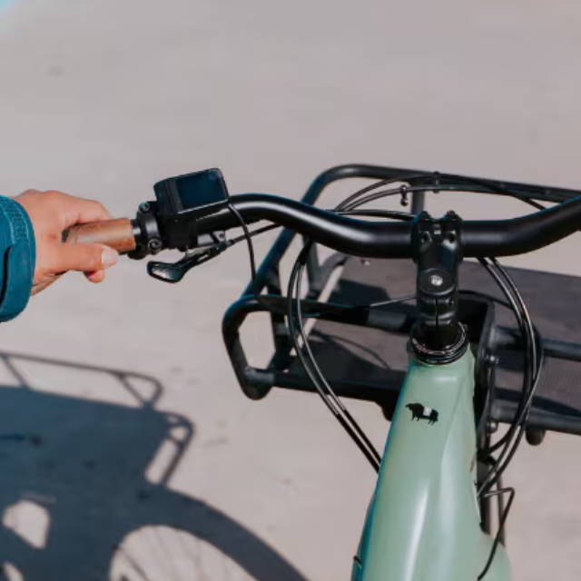 a man standing next to an electric city bike