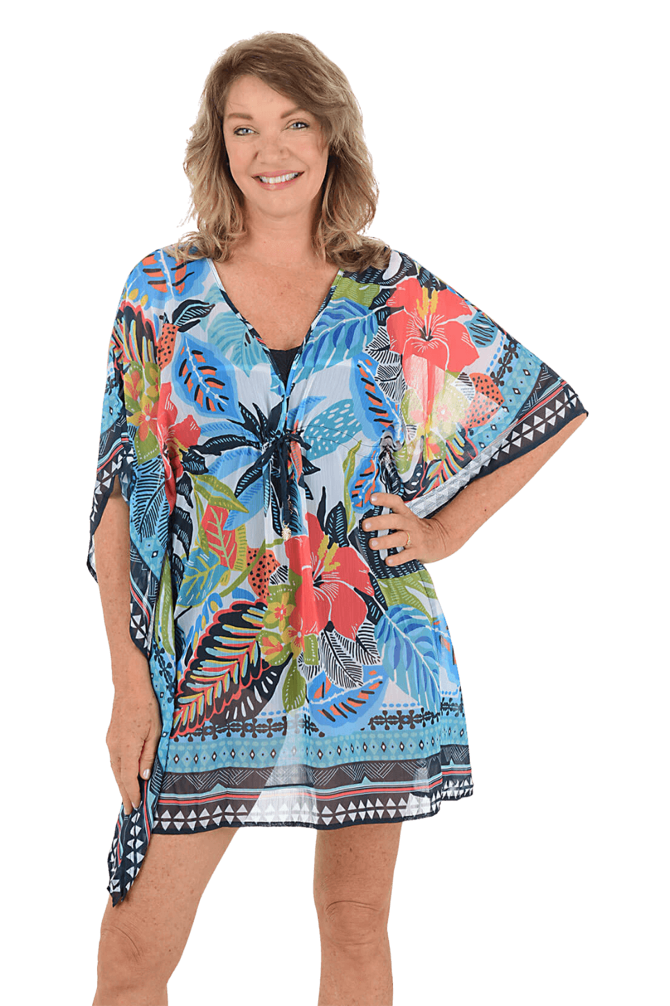 A woman wears a printed caftan cover-up against a blue background
